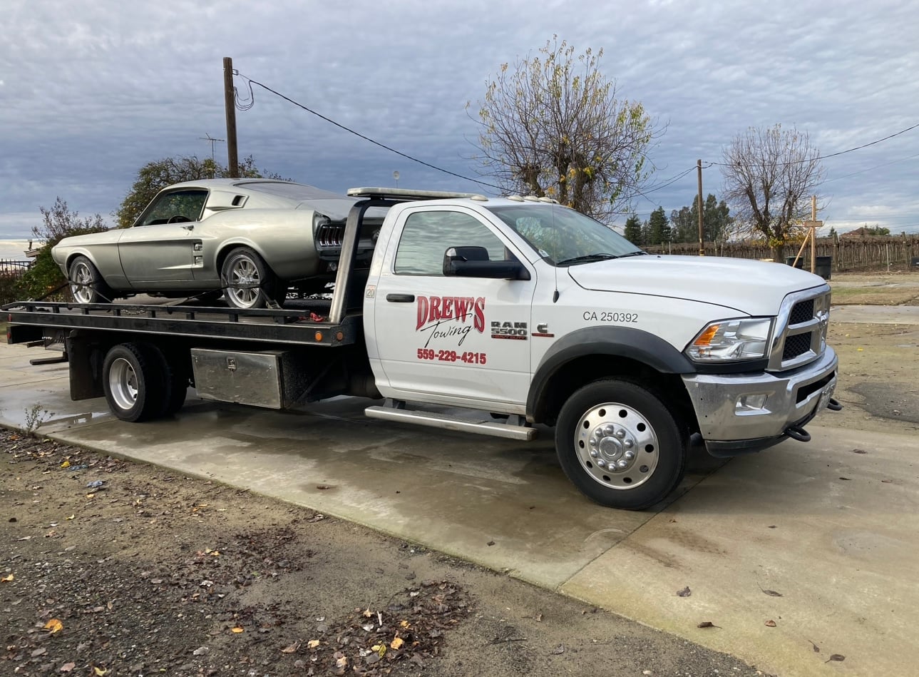 Drew's Towing flatbed truck with classic car
